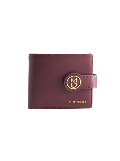 Burgundy leather wallet with 'M. Othello' branding on a light background