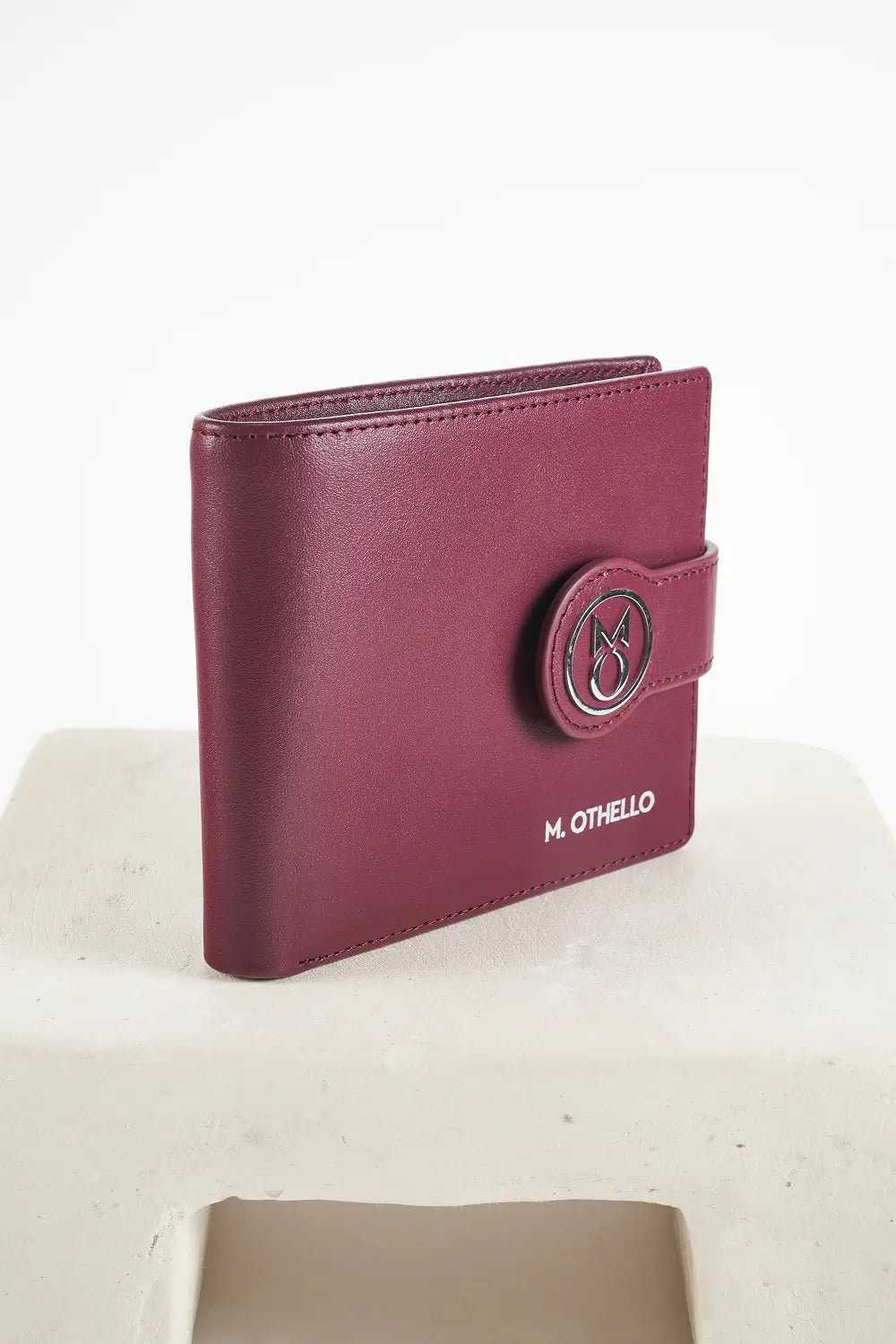 Burgundy bi-fold wallet with brand logo on a light background