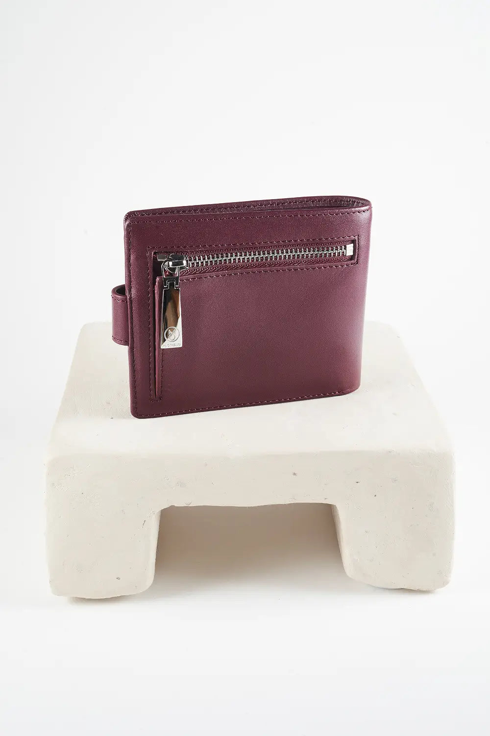 Burgundy bi-fold wallet with brand logo on a light background