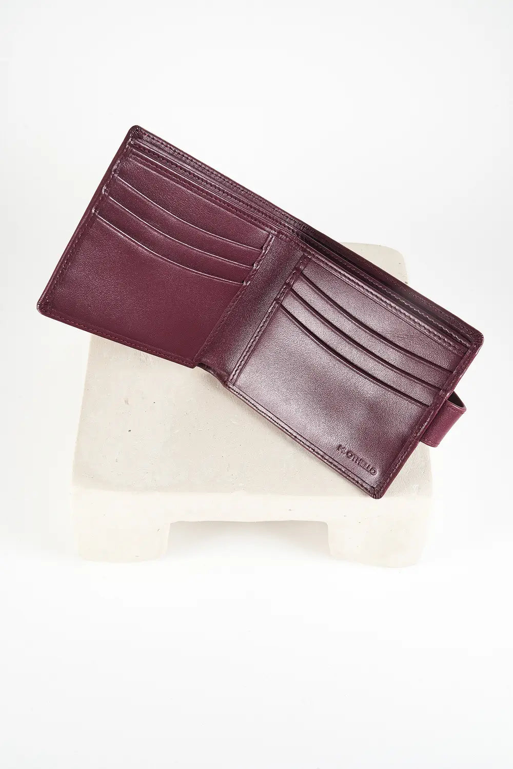 Burgundy bi-fold wallet with brand logo on a light background