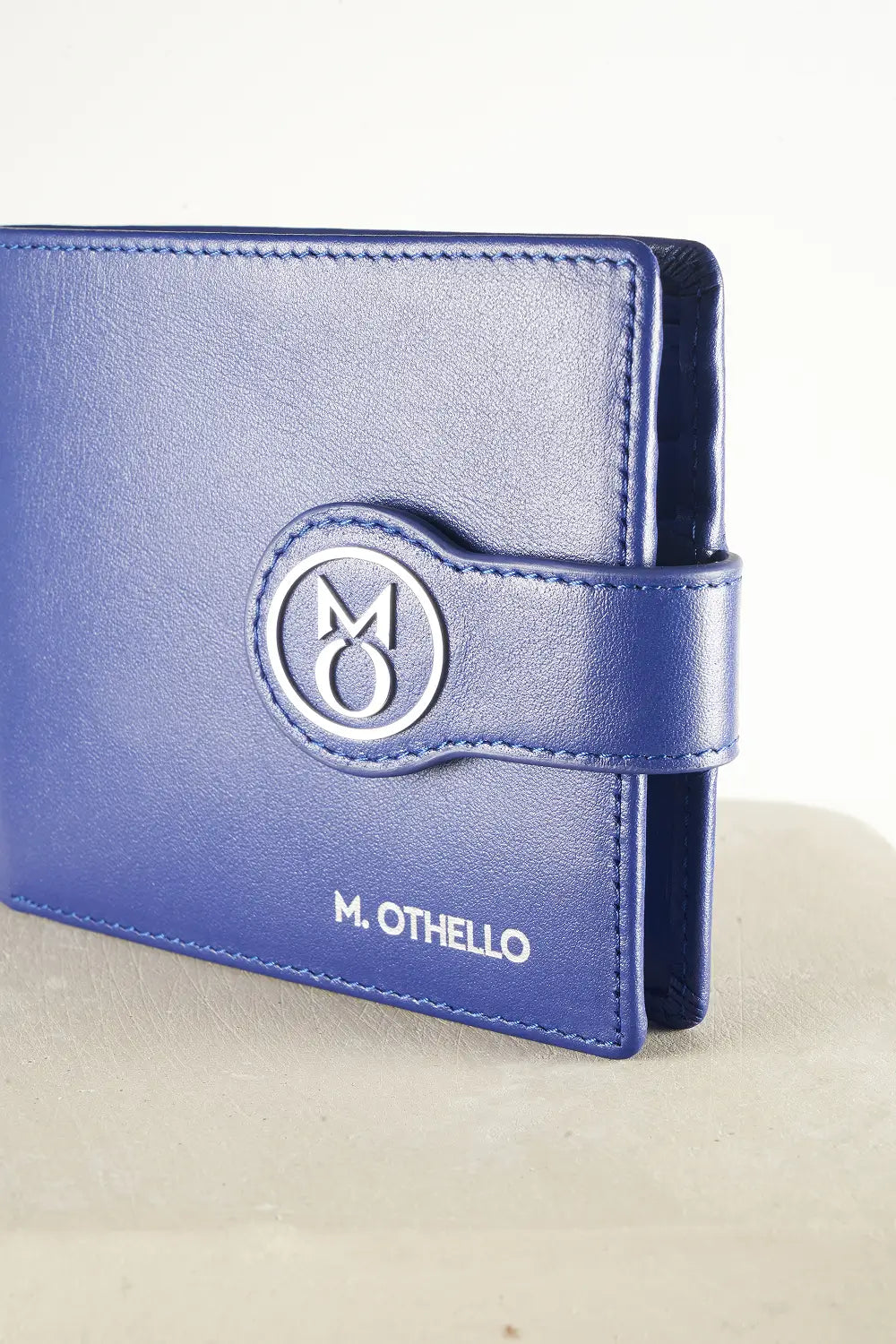 Blue bi-fold wallet with brand logo on a light background