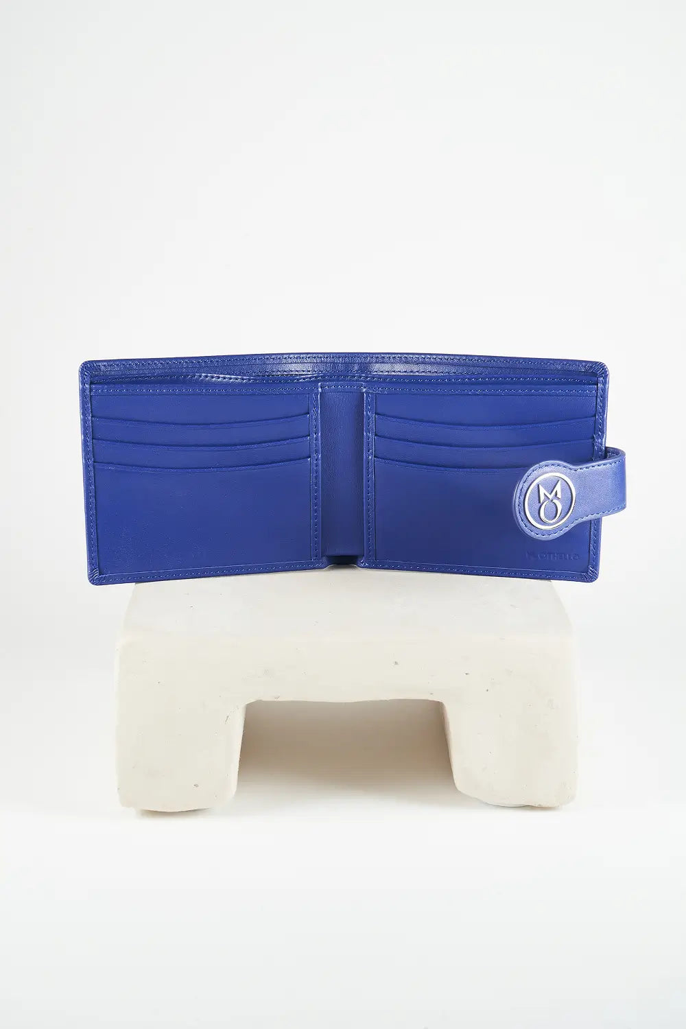 Blue bi-fold wallet with brand logo on a light background