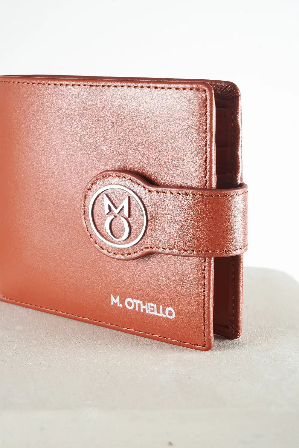 Brown bi-fold wallet with brand logo on a light background