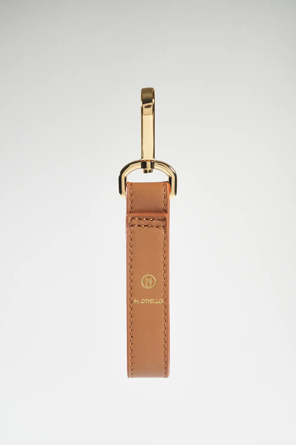 Brown leather keychain with gold clasp on a white background