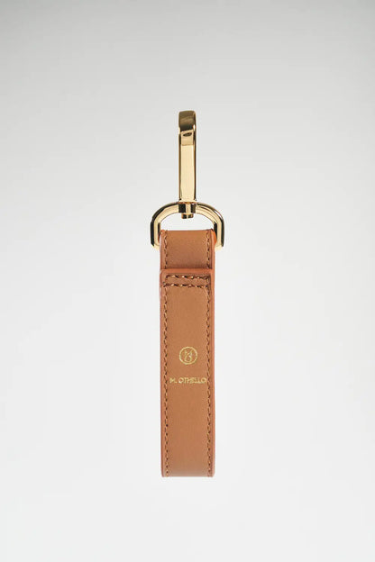 Brown leather keychain with gold clasp on a white background