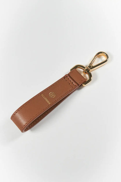 Brown leather keychain with gold clasp on a white background