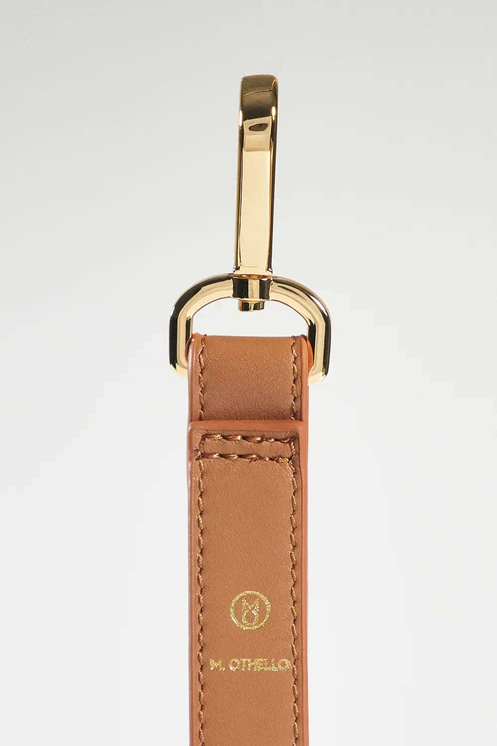 Brown leather keychain with gold clasp on a white background