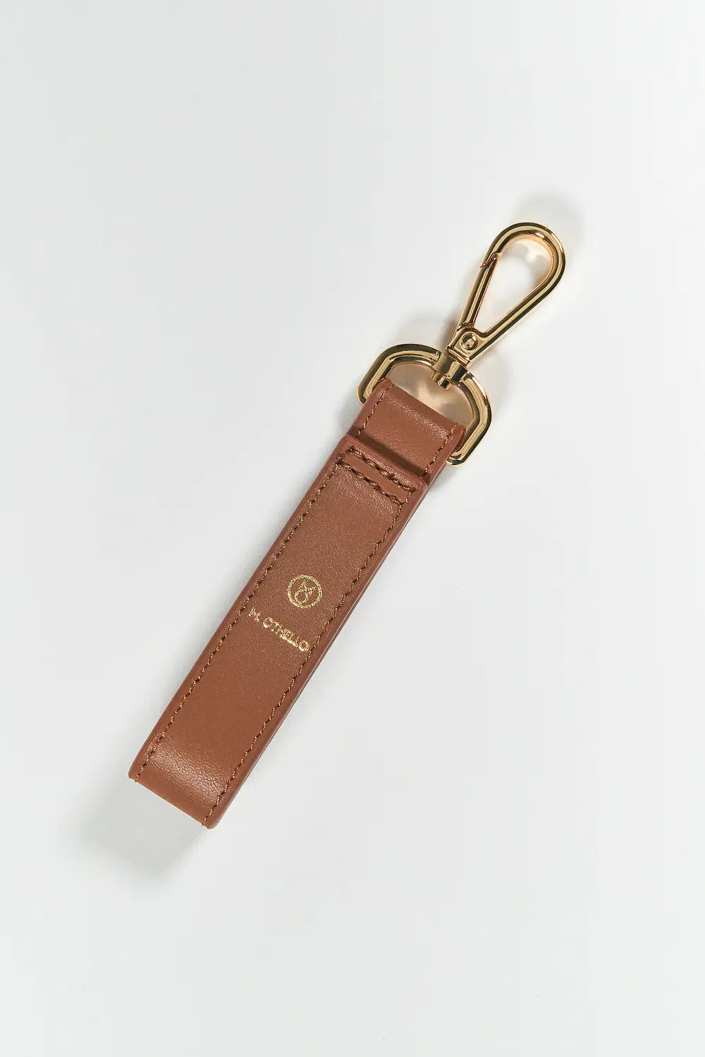 Brown leather keychain with gold clasp on a white background