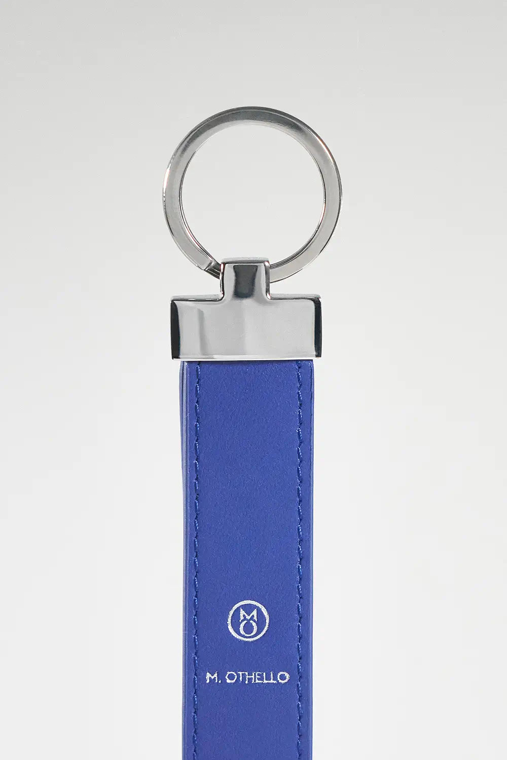 Blue keychain with silver ring on a light gray background