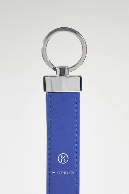 Blue keychain with silver ring on a light gray background