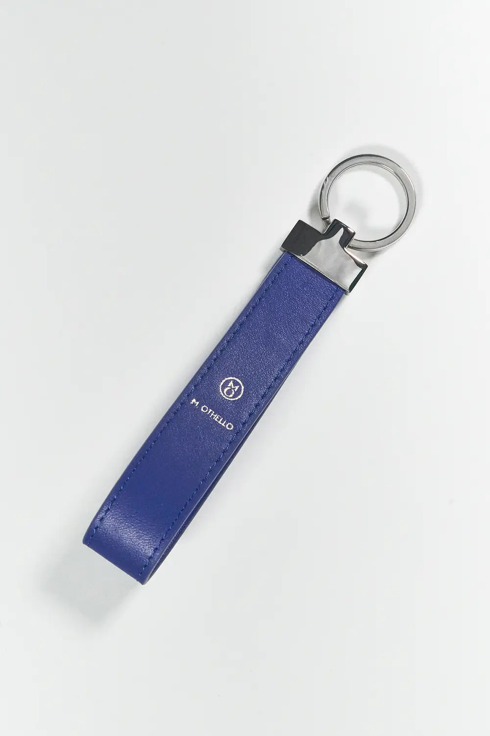Blue keychain with silver ring on a light gray background