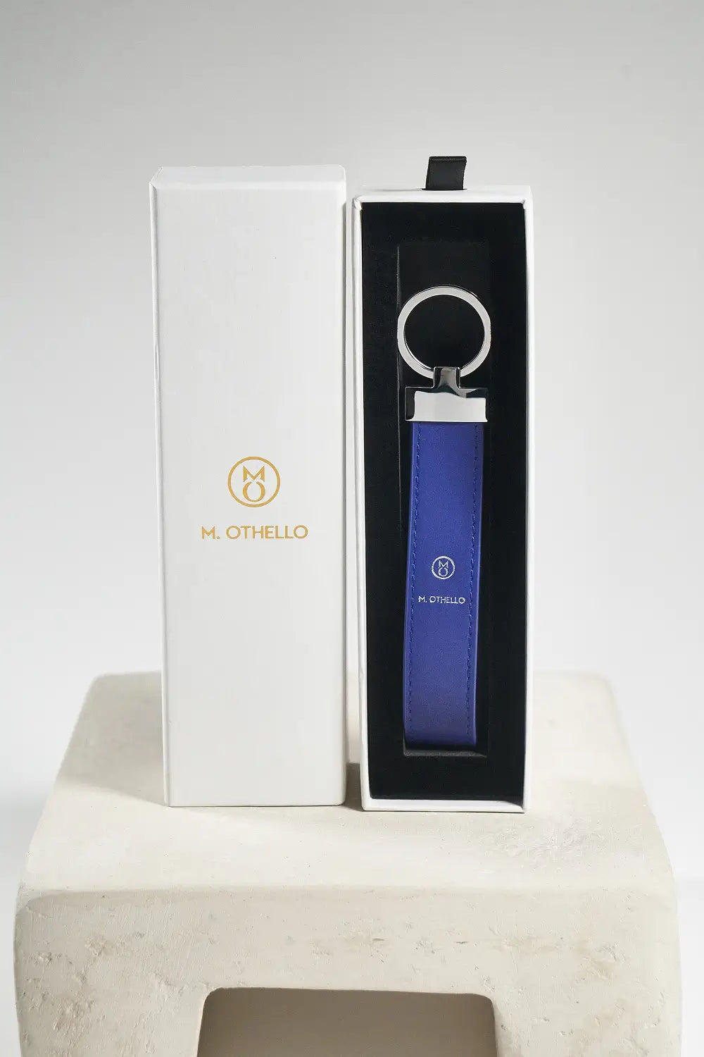 Blue keychain with silver ring on a light gray background