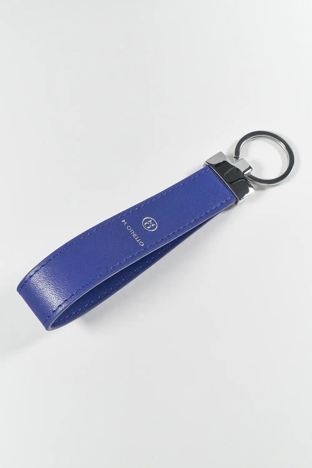Blue keychain with silver ring on a light gray background