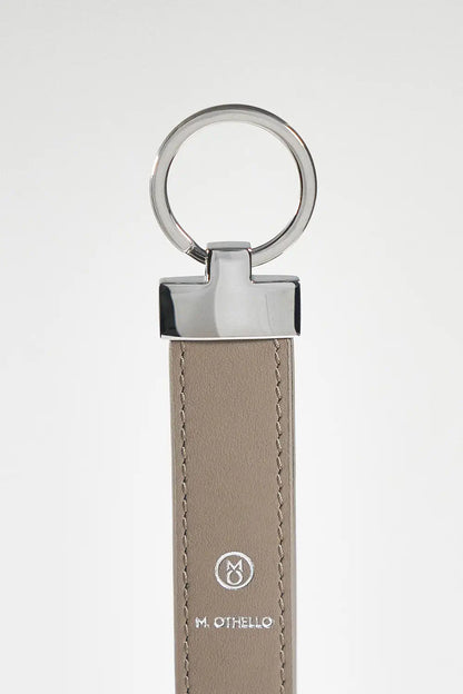 Gray keychain with silver ring on a light gray background