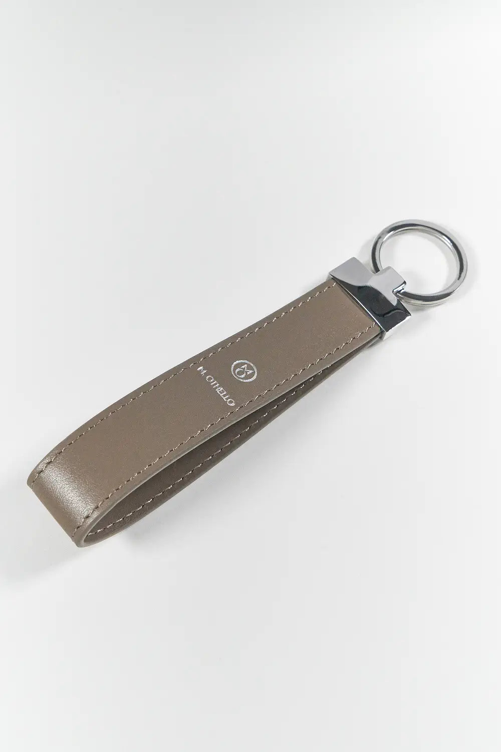 Gray keychain with silver ring on a light gray background