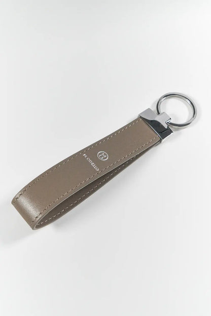 Gray keychain with silver ring on a light gray background