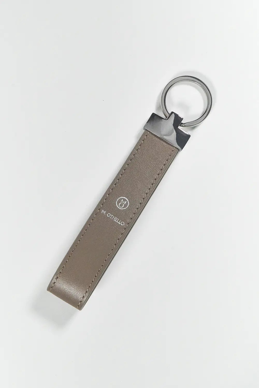 Gray keychain with silver ring on a light gray background