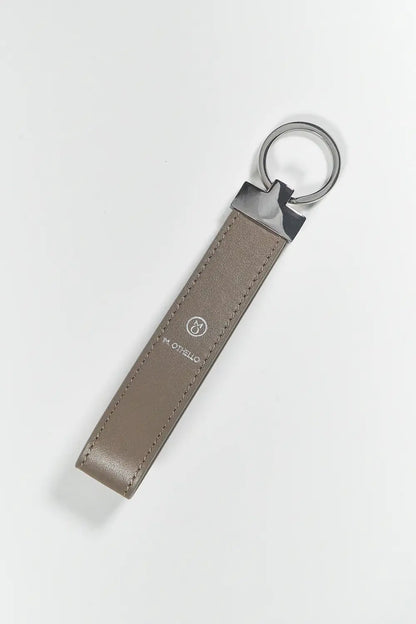 Gray keychain with silver ring on a light gray background