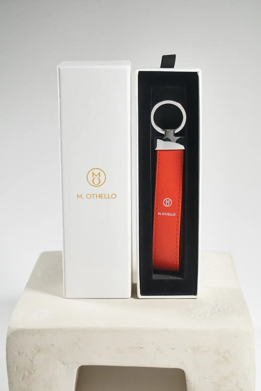 Orange keychain with silver ring on a light gray background