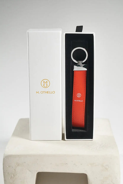 Orange keychain with silver ring on a light gray background