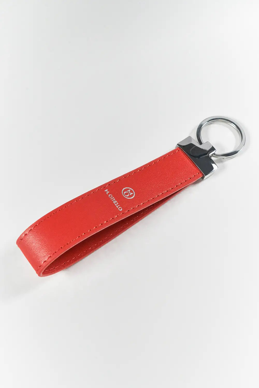 Orange keychain with silver ring on a light gray background