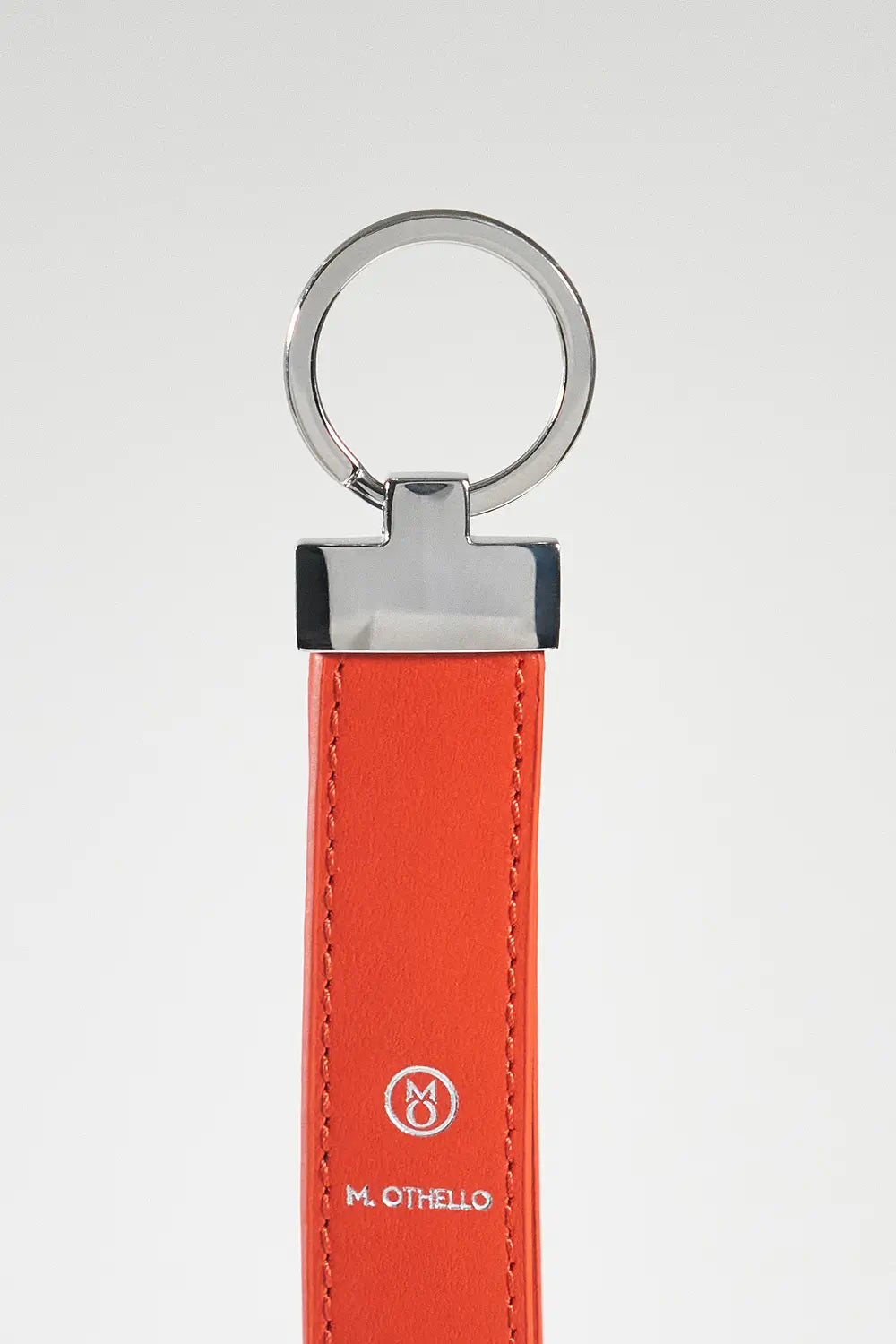 Orange keychain with silver ring on a light gray background