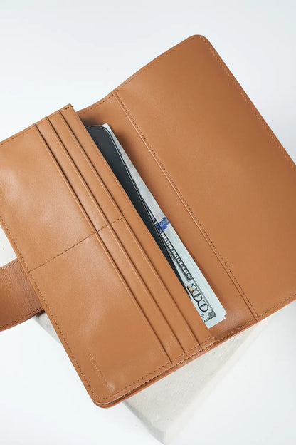 Brown leather wallet with a visible brand label on a white background