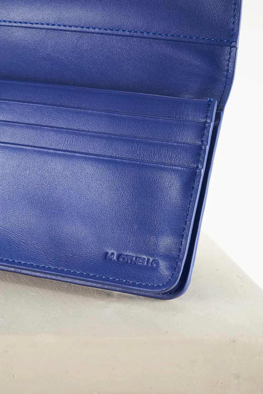 Blue wallet with brand logo on a light background