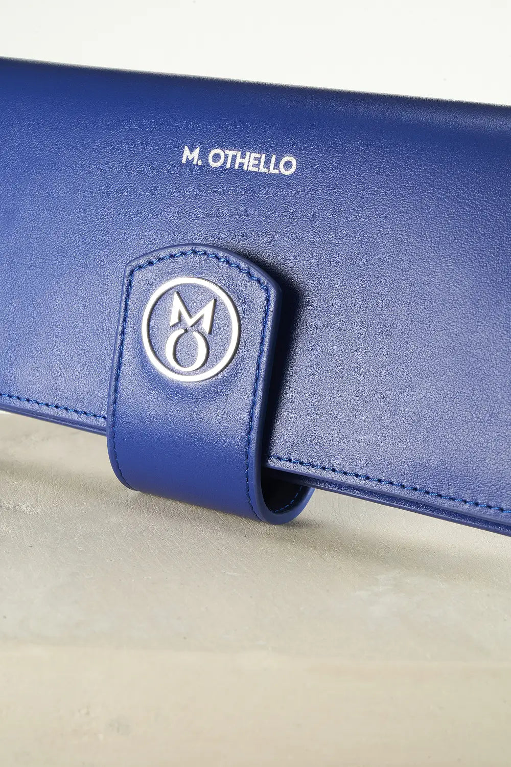 Blue wallet with brand logo on a light background