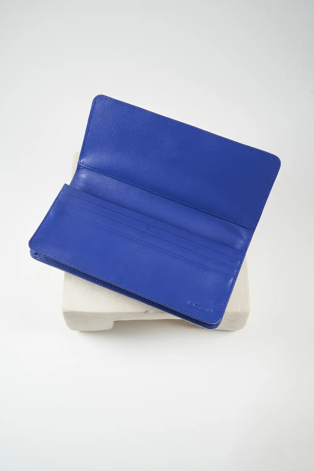 Blue wallet with brand logo on a light background