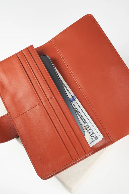 Brown leather wallet with a visible brand label on a white background