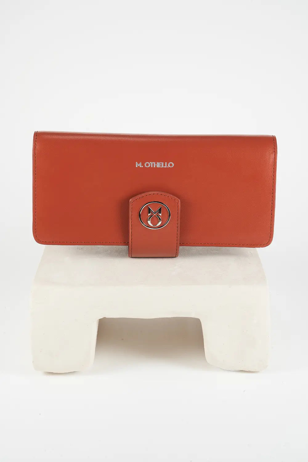 Brown leather wallet on a white surface