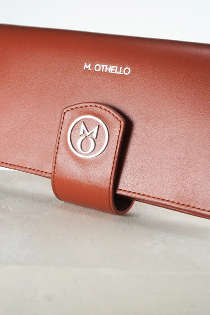 Brown leather wallet with 'M. Othello' branding on a light background