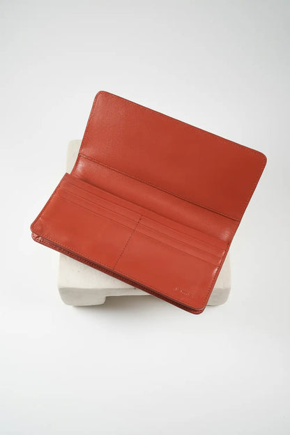Brown leather wallet on a white surface