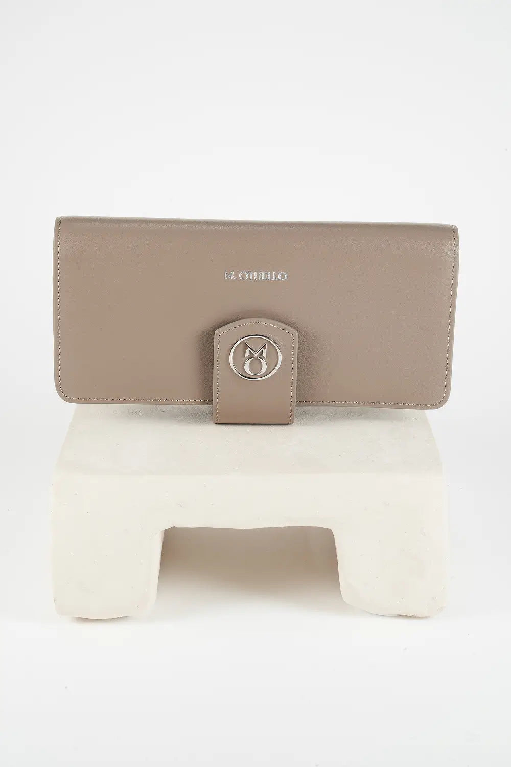 Gray leather phone wallet with 'M. Othello' branding on a light background