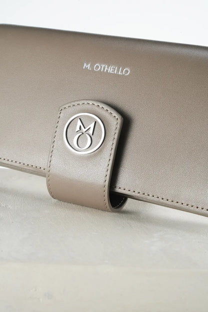 gray leather wallet with 'M. Othello' branding on a light background