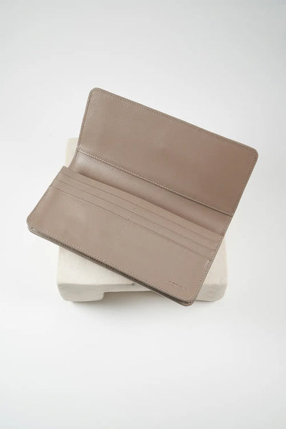 Gray leather phone wallet with 'M. Othello' branding on a light background