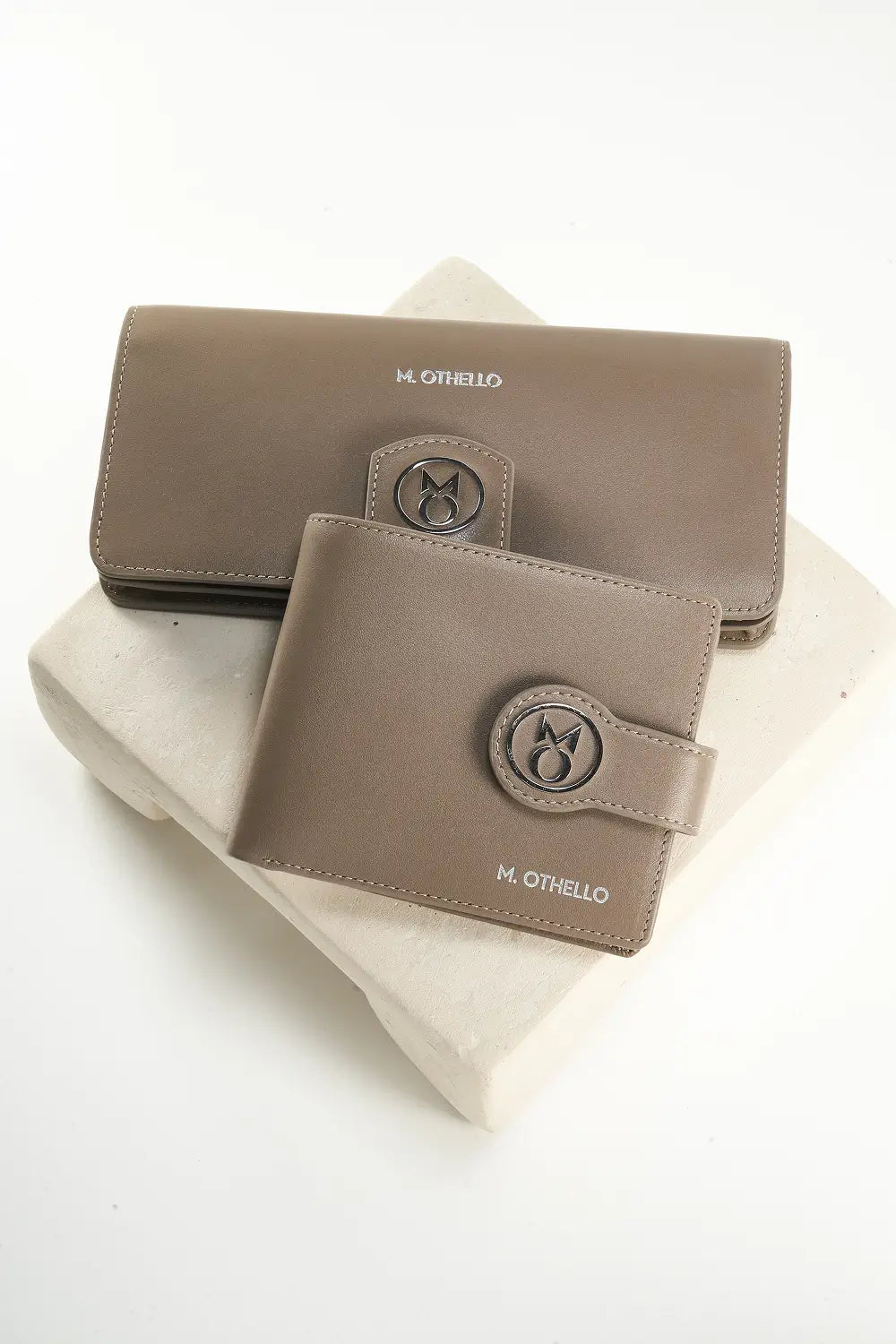 Two gray leather wallets with brand logo on a white background