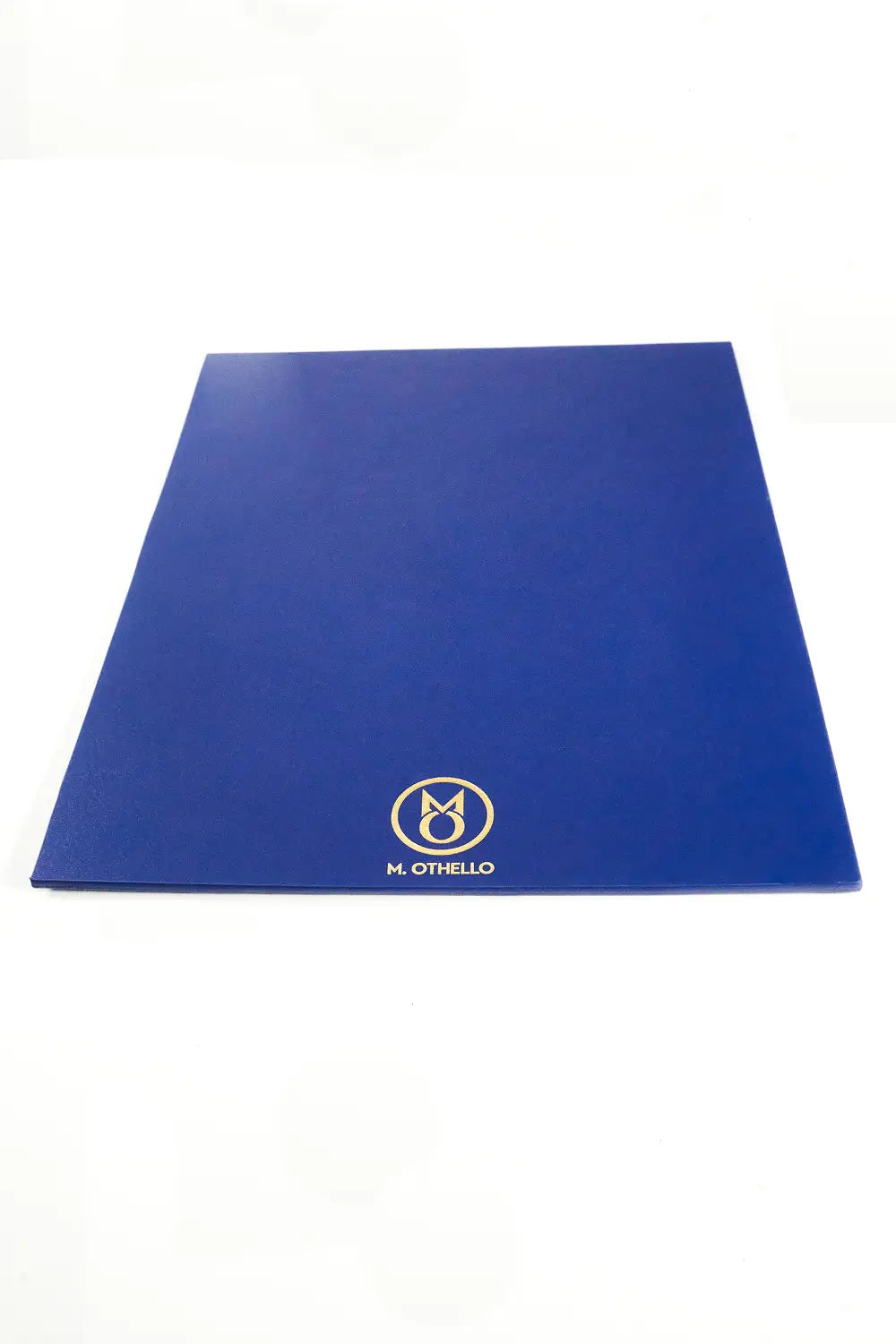 Blue leather mousepad with 'M. Othello' logo on a light background