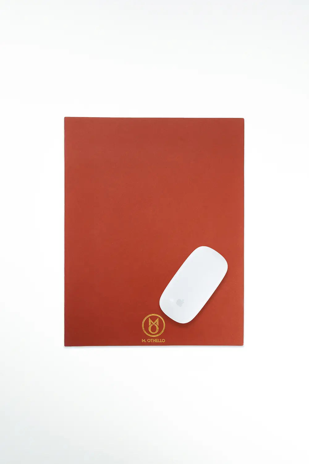 Brown leather mousepad with 'M. Othello' logo on a light background