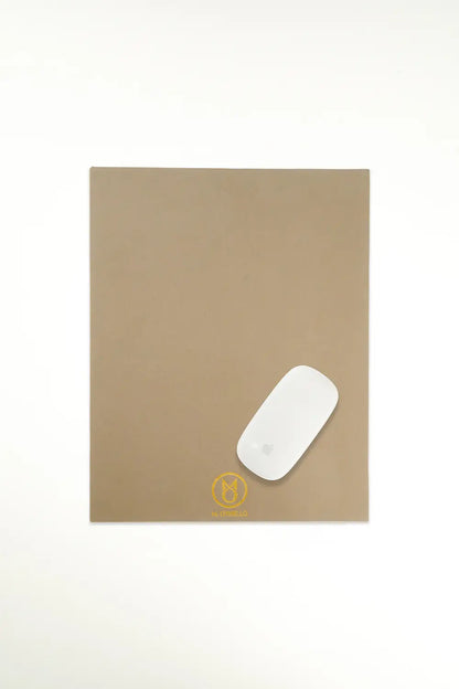 Gray leather mousepad with 'M. Othello' logo on a light background